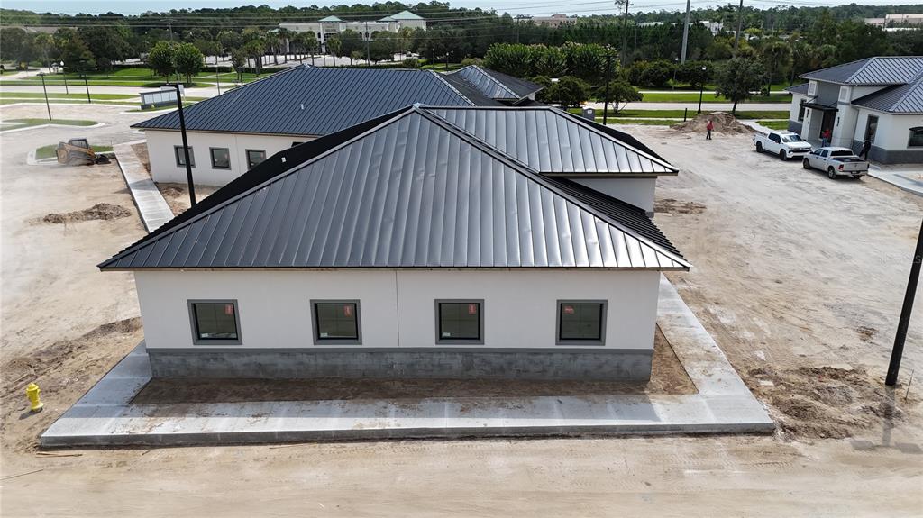 An aerial view shows the concrete block walls of a building under construction — 75 EXCHANGE LOOP LOOP UNIT 8, PALM COAST, FL