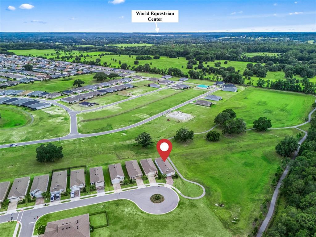 An aerial view shows a suburban neighborhood with houses, a cul-de-sac, and green fields — 5478 NW 46TH LANE RD, OCALA, FL