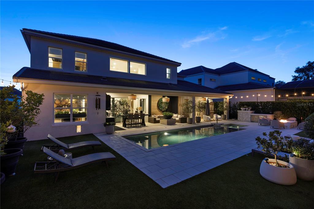 An aerial view shows a house with a brown tiled roof, pool, and paved driveway — 1659 CANYON OAK WAY, SANFORD, FL