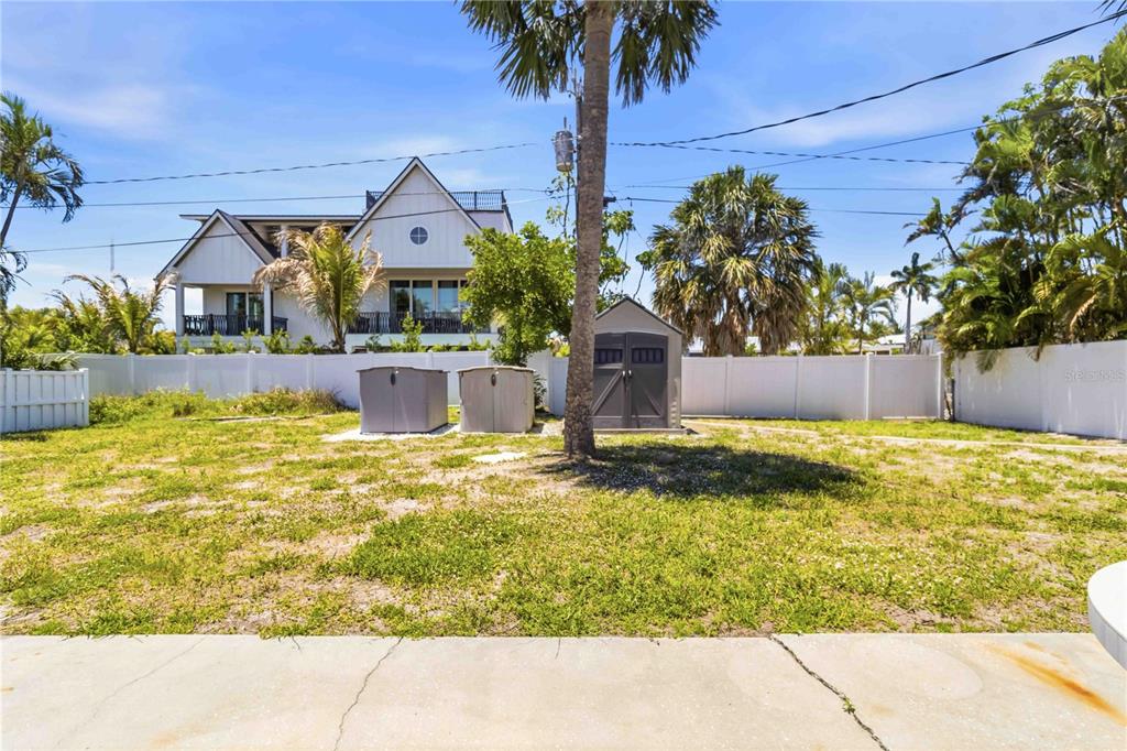 A single-story house with a red tile roof, white stucco walls, and two palm trees — 306 PALM AVENUE, ANNA MARIA, FL