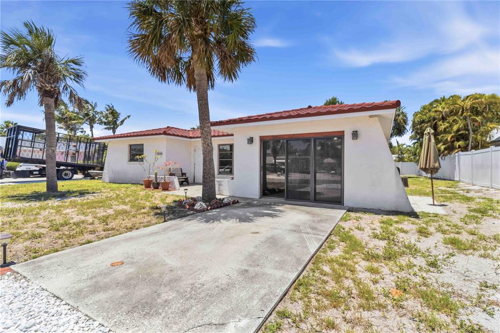 A single-story house with a red tile roof and two palm trees in the yard — 306 PALM AVENUE, ANNA MARIA, FL