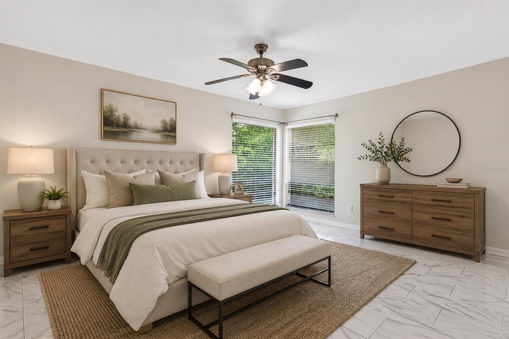 A bedroom features a tufted headboard, a wooden dresser, a ceiling fan, and tile flooring — 300 DUBLIN DRIVE, LAKE MARY, FL