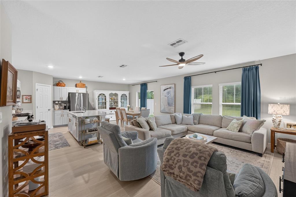 A hallway leads to a living room, with a powder room visible on the right — 7723 DEPOT LOOP, PARRISH, FL