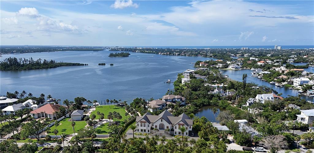 An aerial view shows a large waterfront estate with a pool and lush landscaping — 546 FREELING DRIVE, SARASOTA, FL