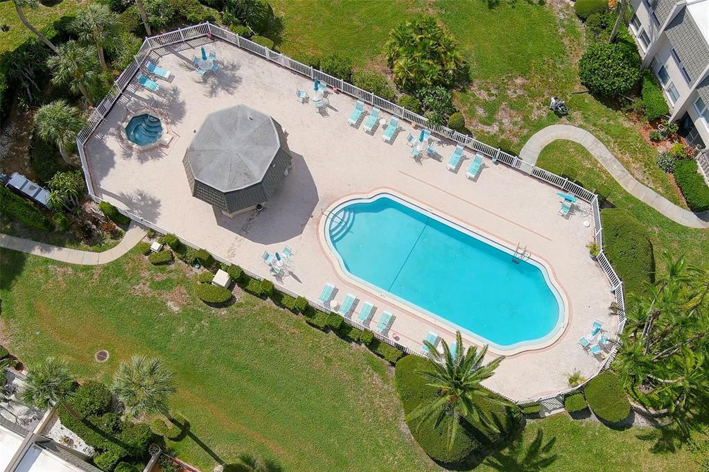 An aerial view of a swimming pool, hot tub, and gazebo surrounded by a fenced patio — 719 CORDOVA GREEN UNIT 719, SEMINOLE, FL