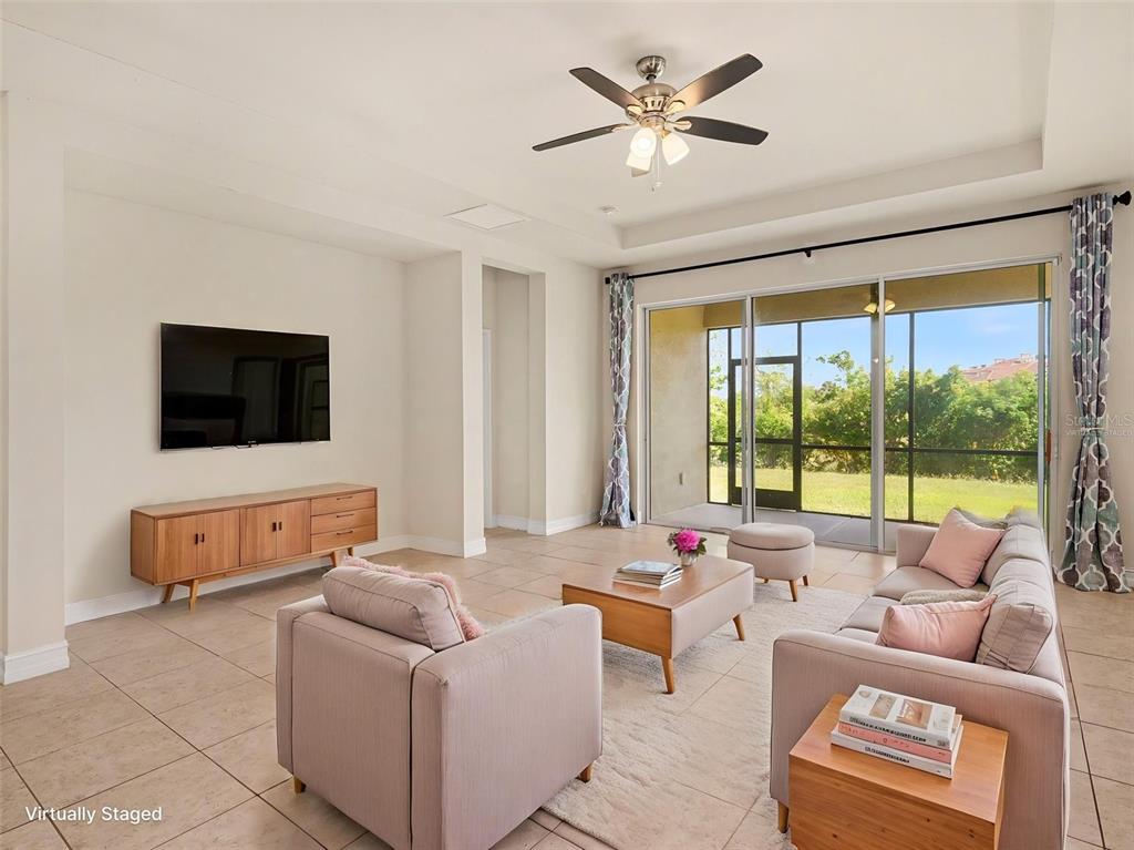 A kitchen island with a stainless steel dishwasher sits in an open-concept room with tile floors — 4429 CONCHFISH LANE, OSPREY, FL