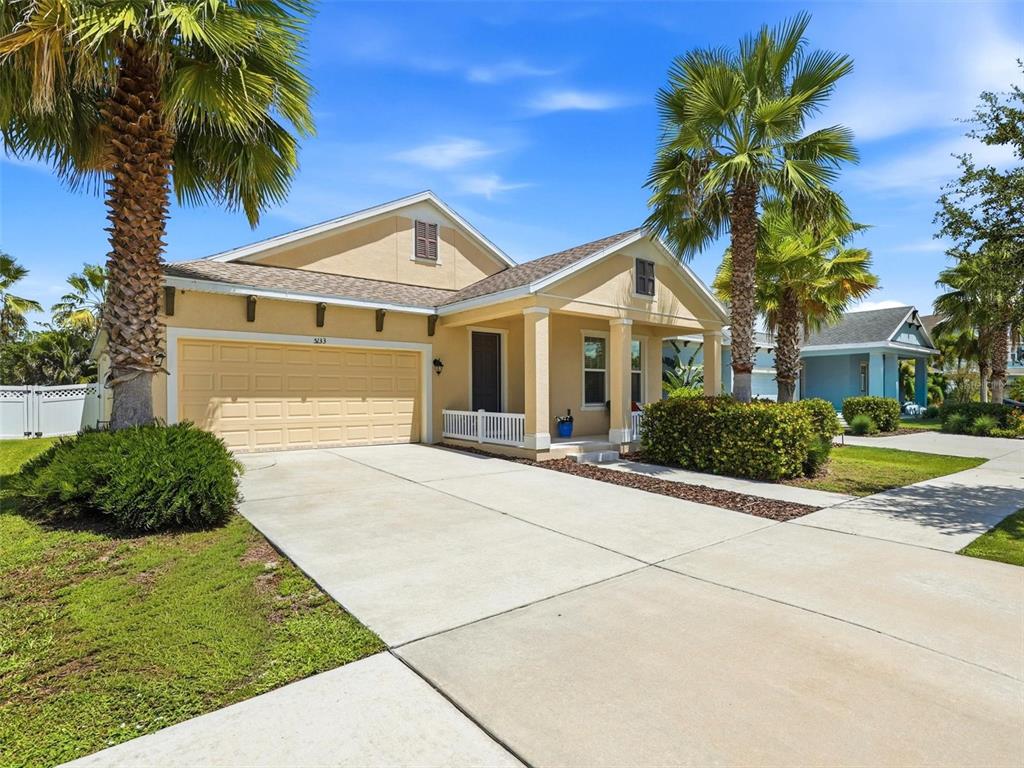 A tan single-story house with a two-car garage and palm trees in the front yard — 5133 ADMIRAL POINTE DRIVE, APOLLO BEACH, FL