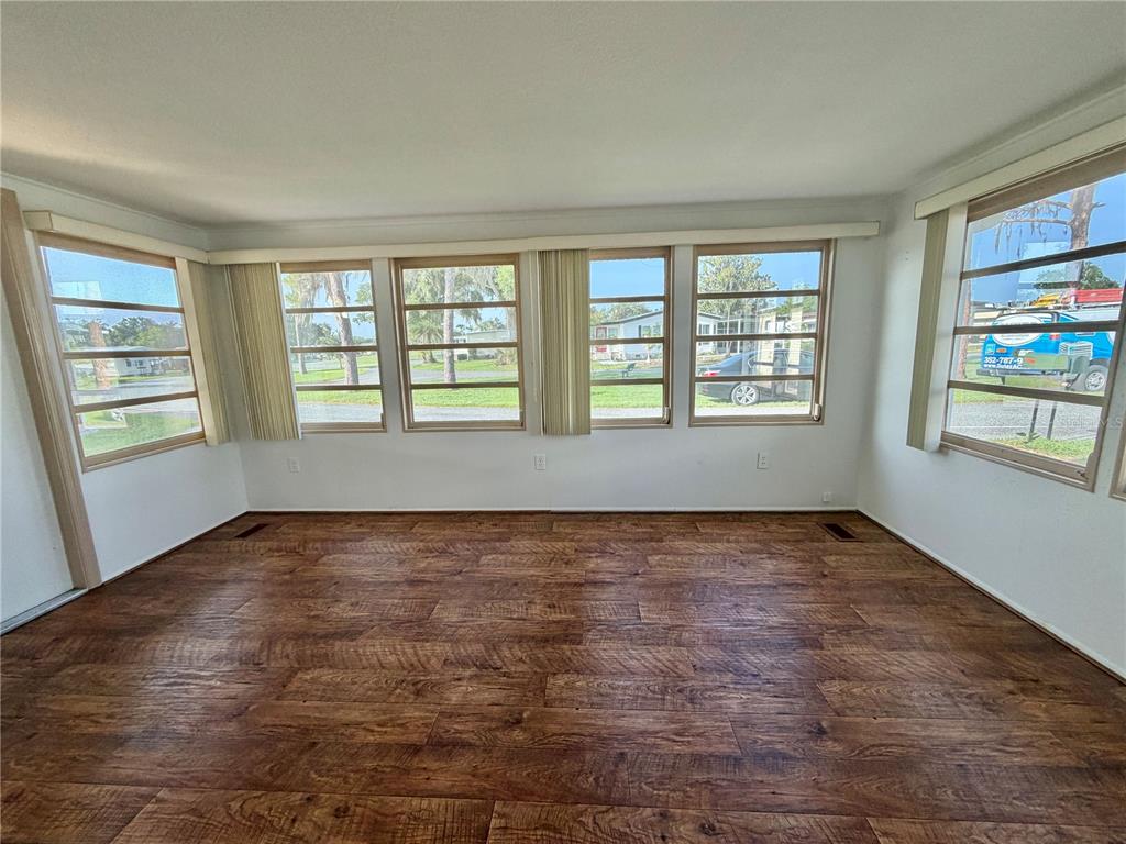 A yellow manufactured home with a covered carport and a stamped concrete driveway — 416 PALO VERDE DRIVE, LEESBURG, FL