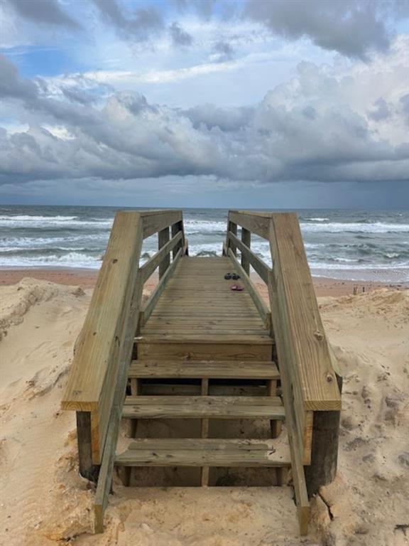 A low-rise apartment building sits atop a sandy dune overlooking a wide beach — 2700 OCEAN SHORE BOULEVARD UNIT 504, ORMOND BEACH, FL