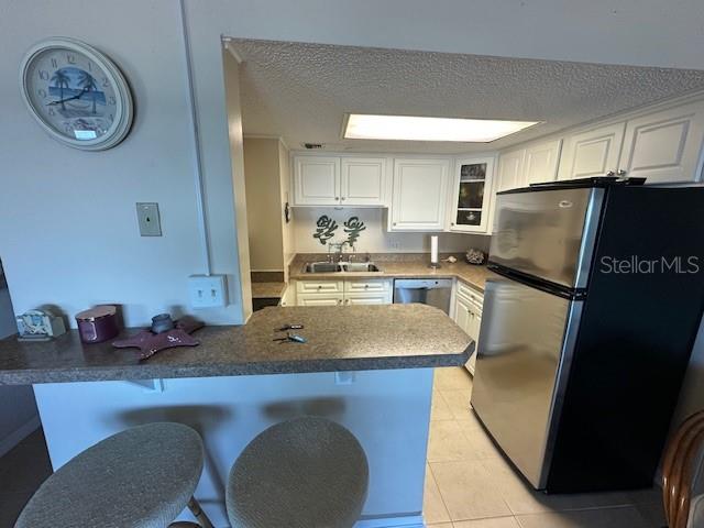 A wooden staircase leads from a sandy dune toward the ocean under a cloudy sky — 2700 OCEAN SHORE BOULEVARD UNIT 504, ORMOND BEACH, FL