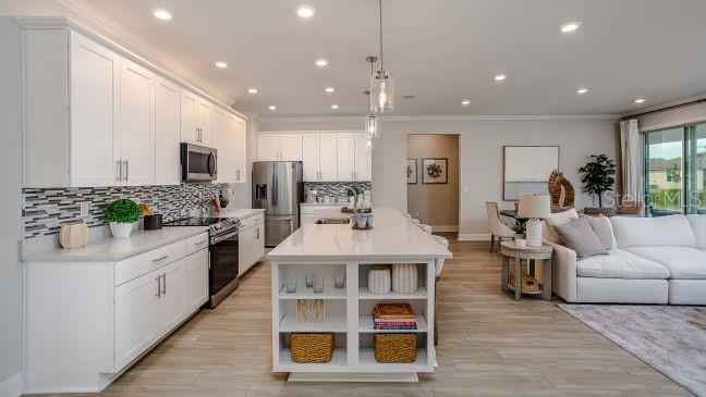 A modern kitchen with white cabinets, a large island, and stainless steel appliances — 16492 CRANE ROAD, WEEKI WACHEE, FL