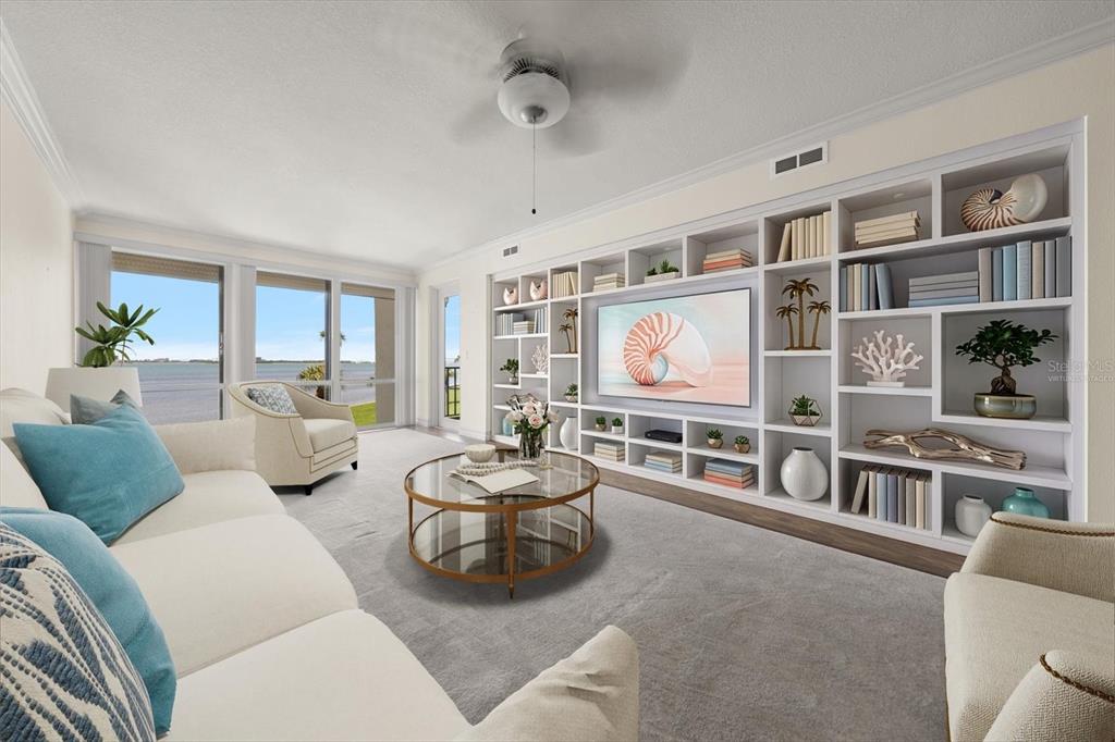 A living room features a large built-in shelving unit, a television, and floor-to-ceiling windows — 50 COE ROAD UNIT 123, BELLEAIR, FL