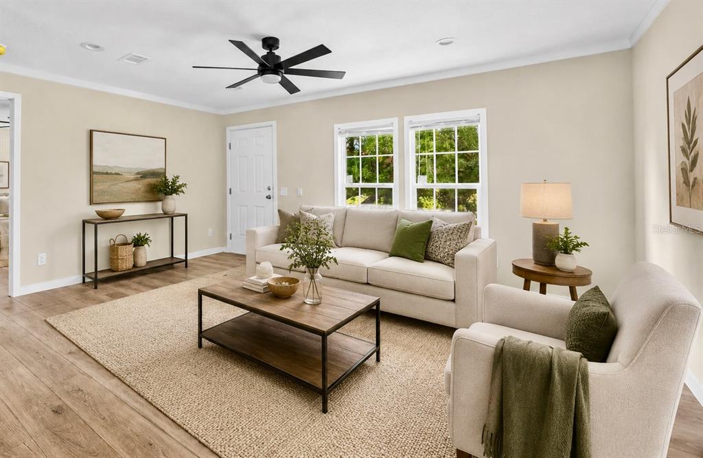 A living room features a beige sofa, armchair, coffee table, and a ceiling fan — 16918 NW 264TH STREET, OKEECHOBEE, FL