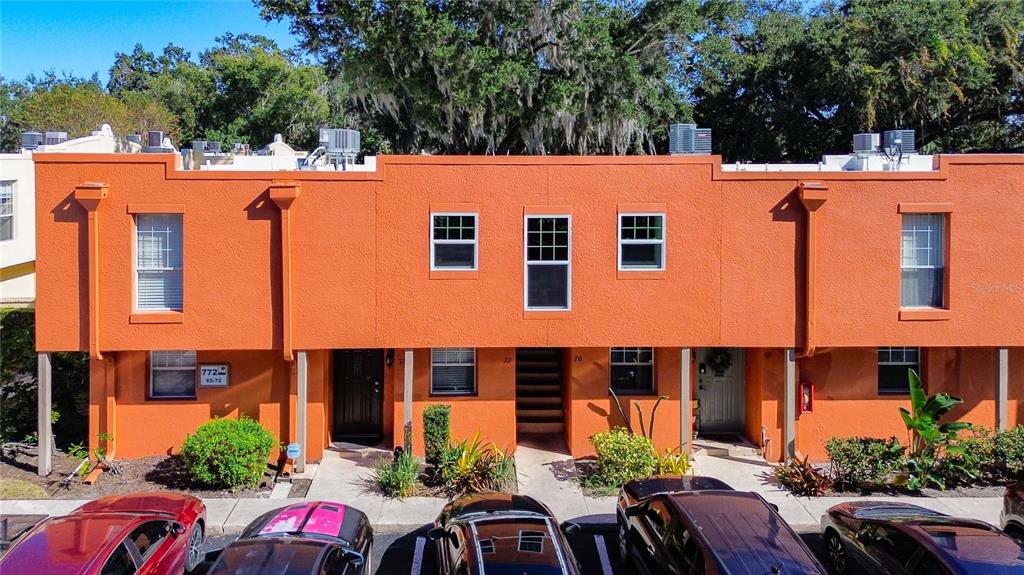 The entrance to La Costa Brava Lakeside Condominiums features two orange stucco towers and signage — 772 E MICHIGAN STREET UNIT 70, ORLANDO, FL