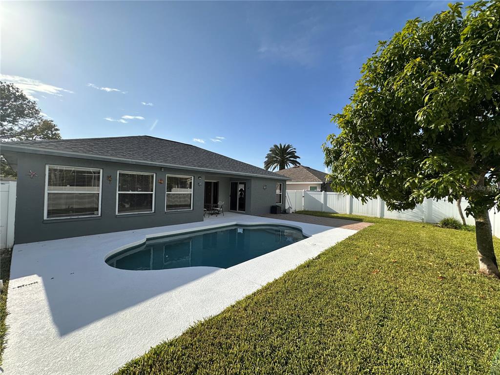 A gray house with a backyard swimming pool and a white vinyl privacy fence — 5010 44TH STREET W, BRADENTON, FL