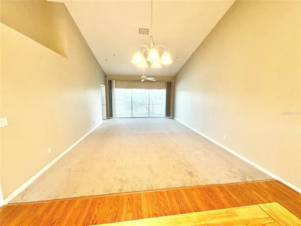 A two-story building features two teal garage doors, matching front doors, and white stucco walls — 6554 FAIRWAY GARDENS DRIVE UNIT 6554, BRADENTON, FL