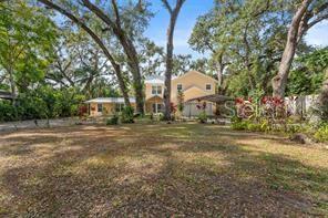 A two-story yellow house with a large yard and many mature trees — 315 WOOTEN ROAD, LUTZ, FL