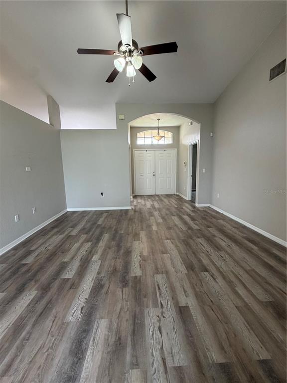 A dining room features a wooden table, six chairs, a chandelier, and wood-look flooring — 5619 FISCHER DRIVE, LAKELAND, FL