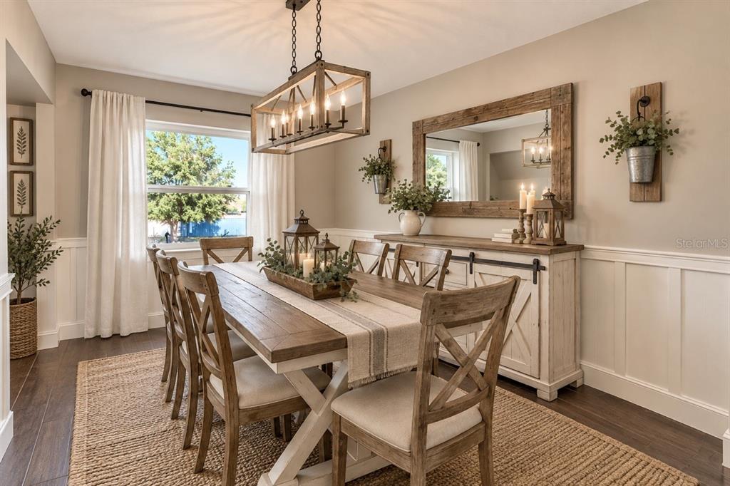 A kitchen with light wood cabinets, a tiled island with bar stools, and stainless steel appliances — 16131 JOHNS LAKE ROAD, CLERMONT, FL