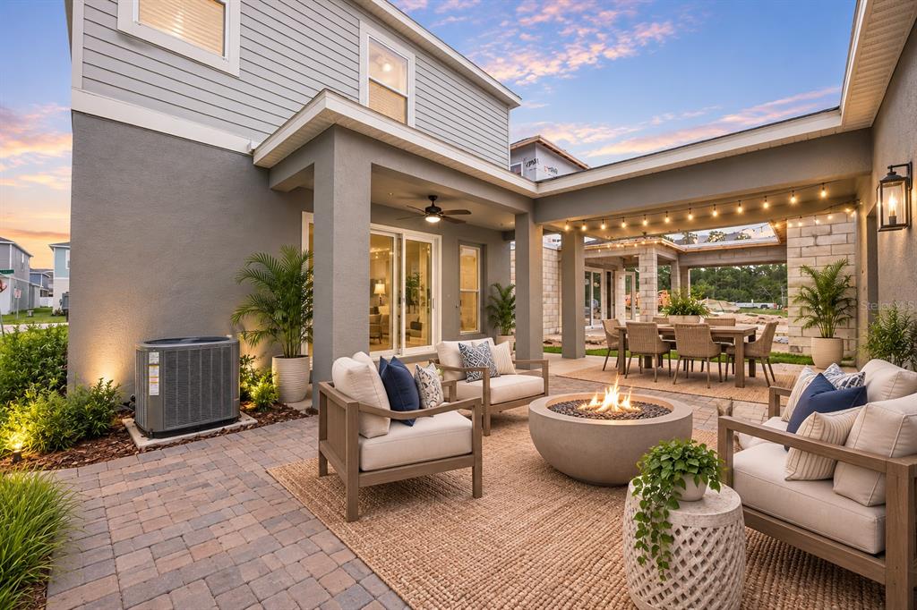 An open-concept kitchen and dining area features white cabinetry, a kitchen island, and tile flooring — 13043 SERENE GLADE ROAD, WINTER GARDEN, FL