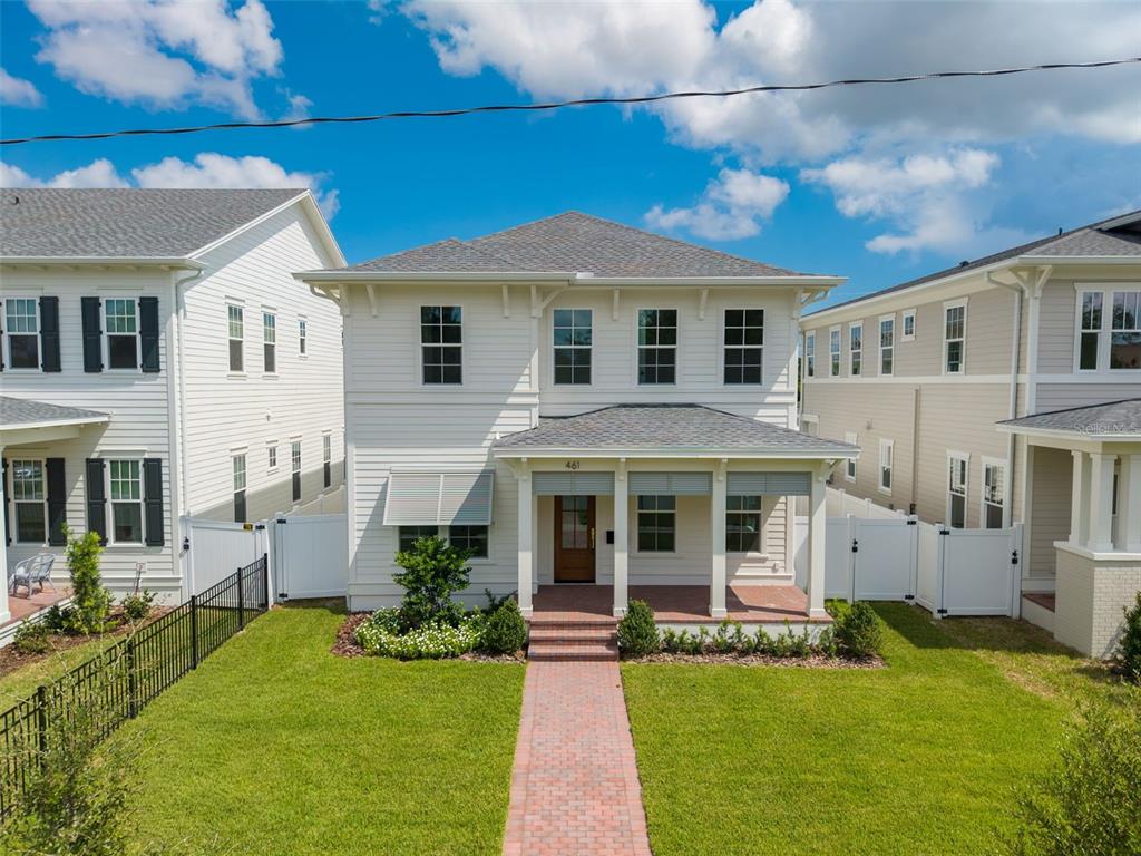 A two-story white house with a front porch and a brick walkway — 461 47TH AVENUE N, ST PETERSBURG, FL
