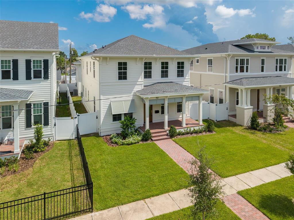 An exterior view of a two-story white house with a front porch and brick walkway — 461 47TH AVENUE N, ST PETERSBURG, FL