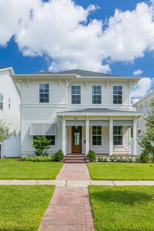 A two-story white house with a front porch, brick walkway, and green lawn — 461 47TH AVENUE N, ST PETERSBURG, FL