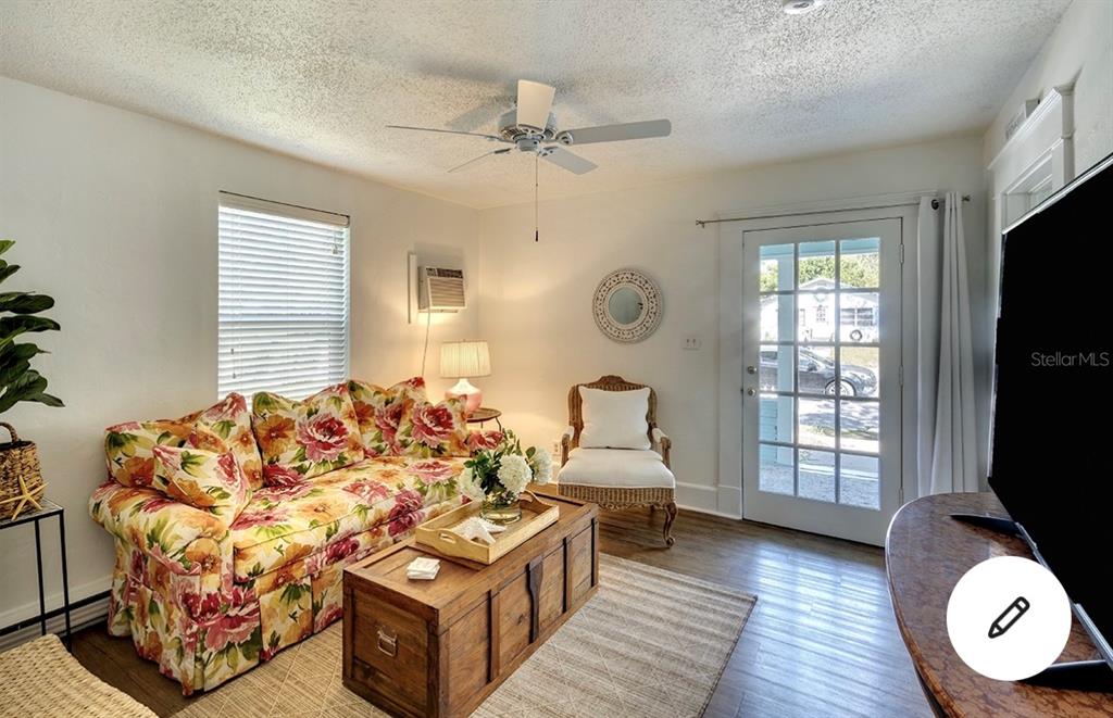 A bedroom features a black bed frame, light-colored bedding, a dresser, and a window with blinds — 2513 8TH AVENUE W, BRADENTON, FL