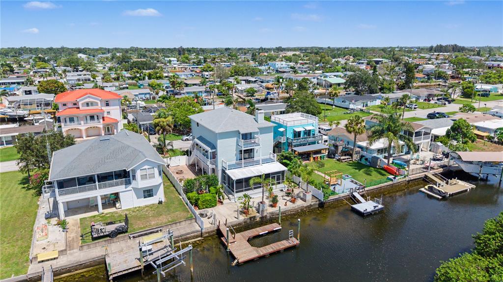 An aerial view shows waterfront houses with private docks along a canal in Florida — 13337 SUSAN DRIVE, HUDSON, FL