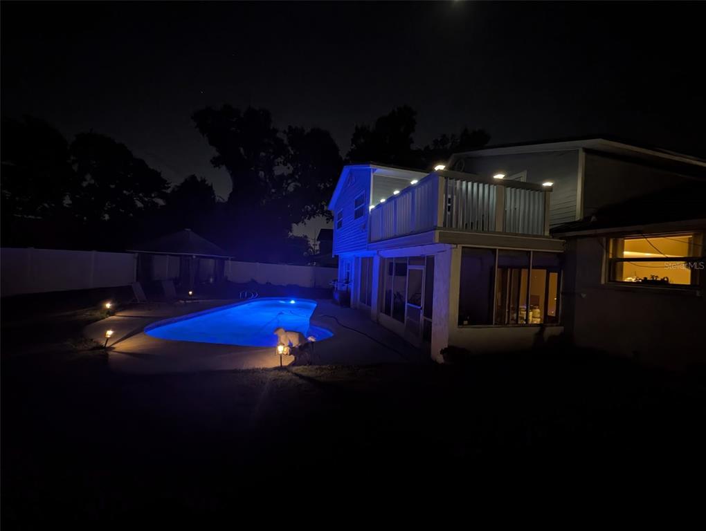 A two-story house with light blue siding, a white garage door, and a red SUV parked outside — 6817 MITCHELL CIRCLE, TAMPA, FL