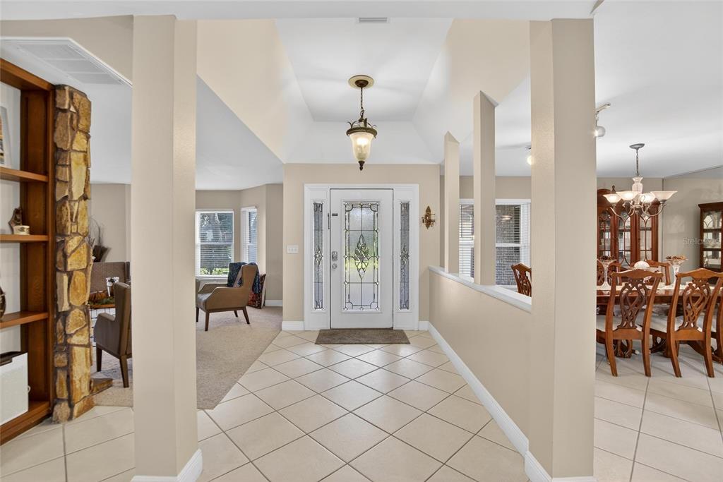 A tiled entryway leads to a front door with sidelights, flanked by a living area and dining room — 133 BARRINGTON DRIVE, BRANDON, FL