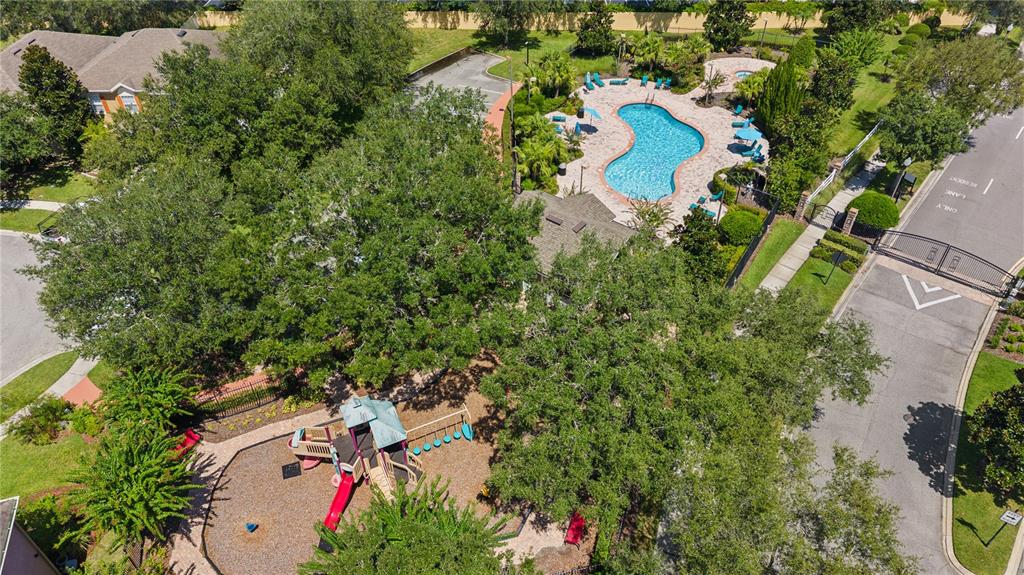 An aerial view shows a community swimming pool, a playground, and a gated entrance — 10313 CYPRESS TRAIL DRIVE, ORLANDO, FL