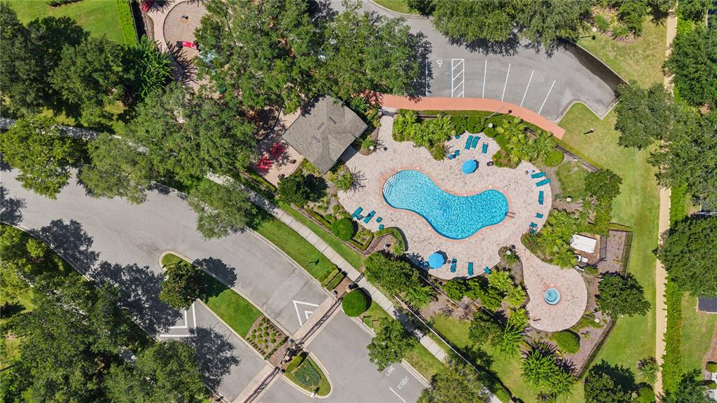 An aerial view shows a community swimming pool, a playground, and a parking lot — 10313 CYPRESS TRAIL DRIVE, ORLANDO, FL