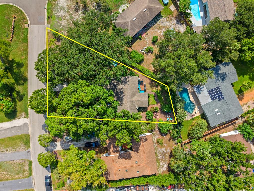 An aerial view shows a residential property with a house, pool, and large trees — 2159 BARCELONA WAY S, ST PETERSBURG, FL