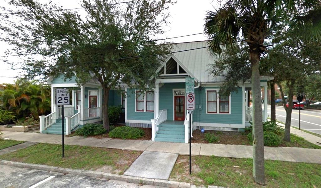 A teal, single-story house with a metal roof, two front porches, and a palm tree — 2002 E 4TH AVENUE, TAMPA, FL