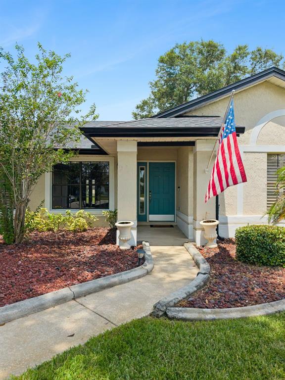 A dining room with a wooden table, six chairs, a rug, and a white front door — 14706 EAGLE VIEW COURT, ORLANDO, FL