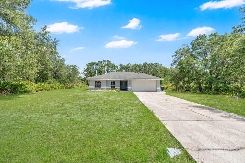 An aerial view shows a single-story house on a large, partially wooded lot — 3450 PARK AVENUE, INDIAN LAKE ESTATES, FL