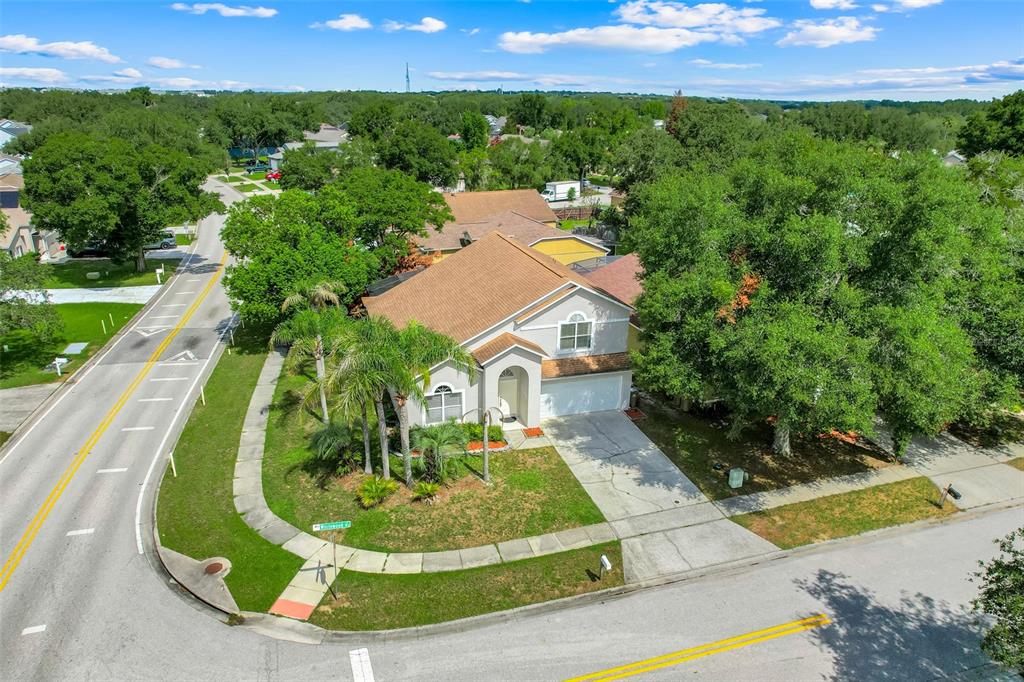 An aerial view shows a suburban house with a brown roof and a concrete driveway — 1324 WHITEWOOD WAY WAY, CLERMONT, FL