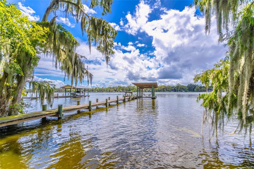 A view of a calm lake at sunset from under a roof overhang — 121 N LAKE GEORGE DRIVE, GEORGETOWN, FL