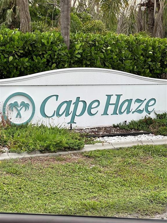A white sign with teal lettering reads Cape Haze in front of a green hedge — 120 SPANIARDS ROAD, PLACIDA, FL