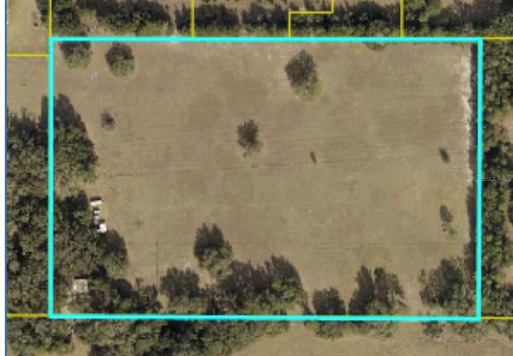 An aerial view shows a rectangular, grassy plot of land outlined in light blue — PARCEL "B" CR 543, SUMTERVILLE, FL