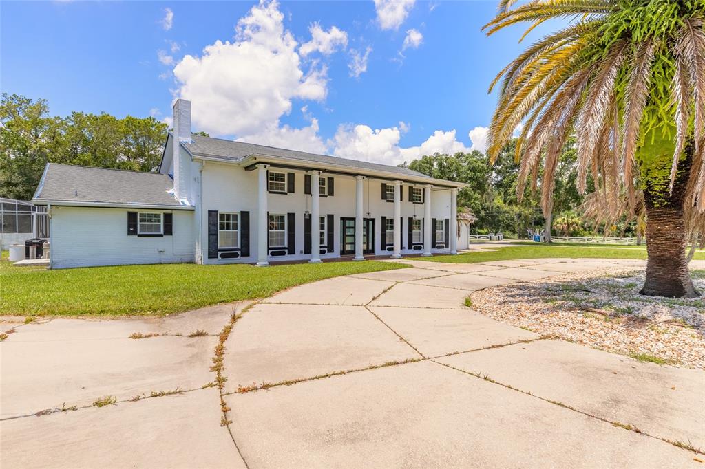 A room with gray walls, a staircase, and a decorative metallic epoxy floor — 2015 HALIFAX DRIVE, PORT ORANGE, FL