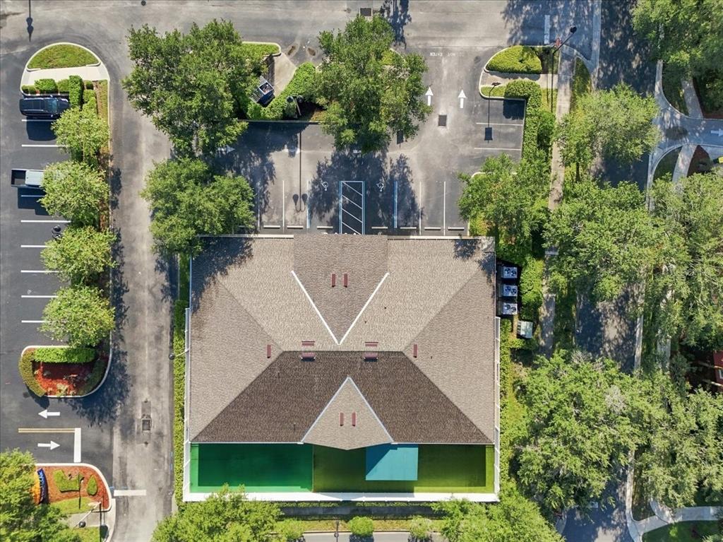 An aerial view shows a commercial building with a shingled roof and a fenced patio — 191 ENDICOTT WAY, DELAND, FL