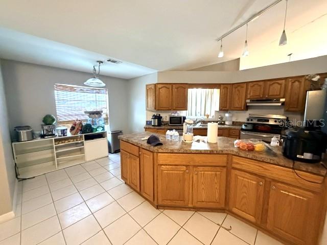 A kitchen features wood cabinets, a central island, tile flooring, and a window with blinds — 1677 SACKETT CIRCLE, ORLANDO, FL