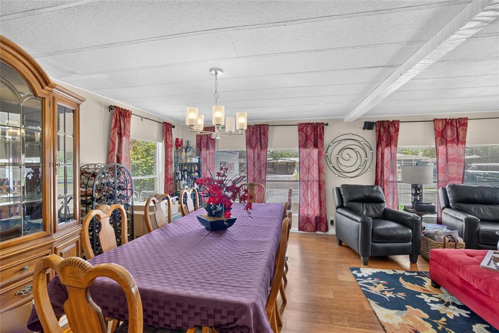 A dining area with a purple tablecloth, wooden chairs, and a black leather armchair nearby — 2715 EATON AVENUE, EATON PARK, FL