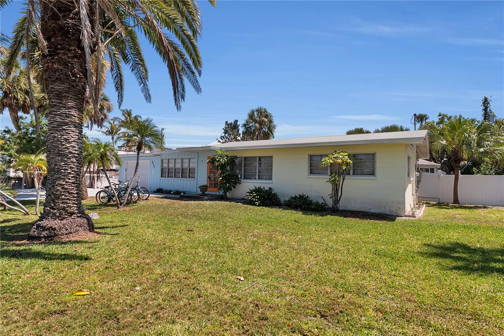 A single-story yellow house with a palm tree in the front yard — 311 59TH STREET, HOLMES BEACH, FL