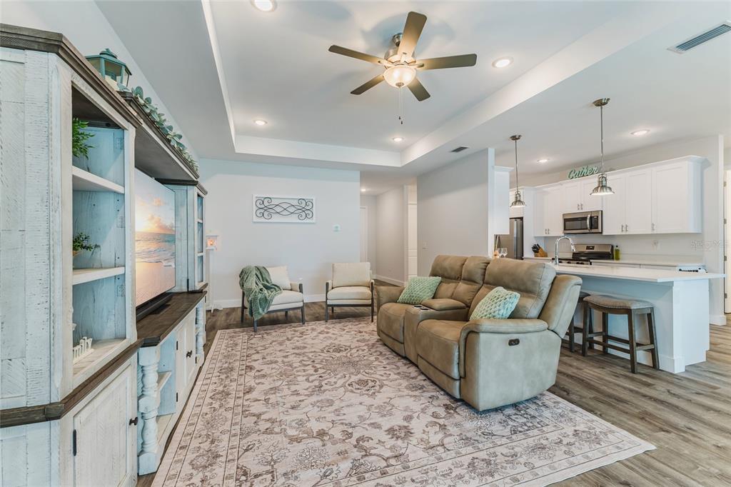 A single-story house with a paved driveway, two garage doors, and light green exterior walls — 908 HIBISCUS AVENUE, LEHIGH ACRES, FL