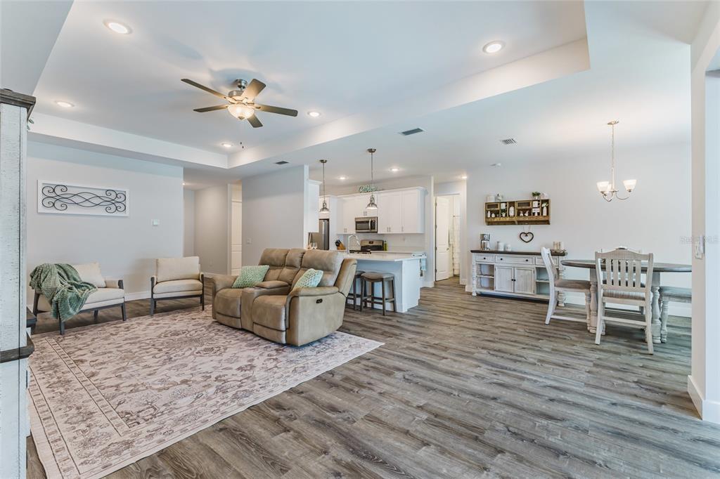 An aerial view shows a single-story house with a garage, fenced yard, and pool enclosure — 908 HIBISCUS AVENUE, LEHIGH ACRES, FL