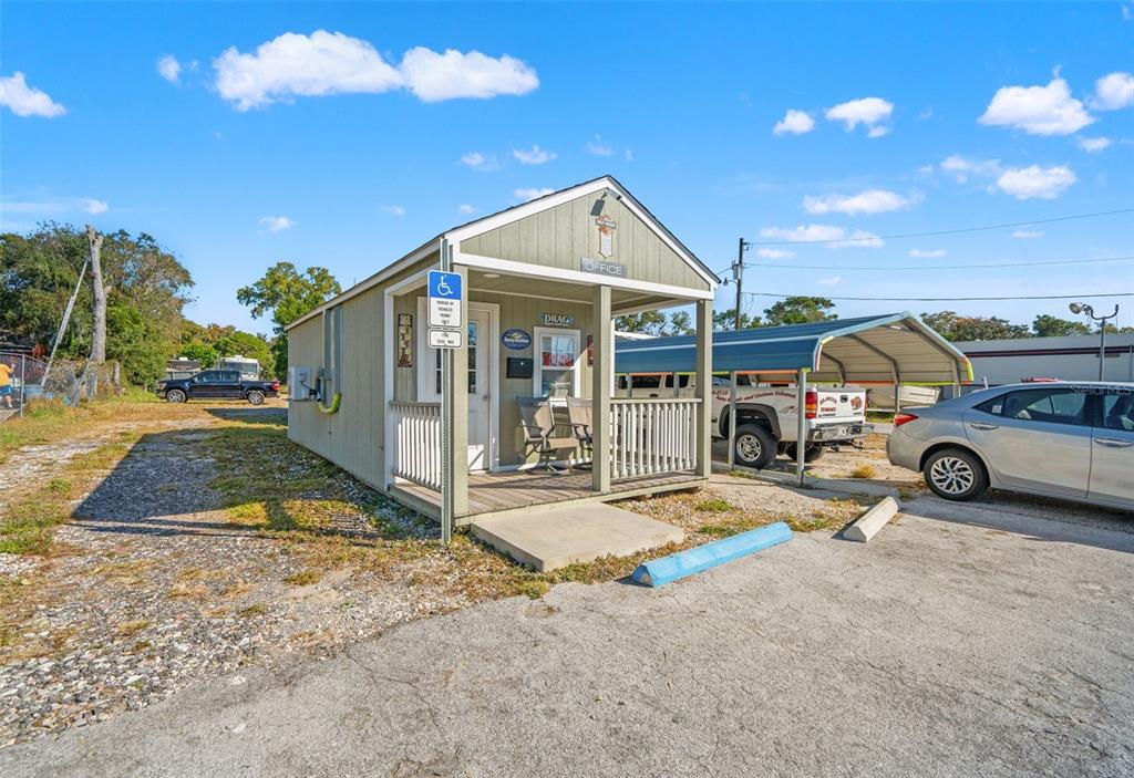 A small, light green office building with a front porch and a handicap parking sign — 9539 STATE ROAD 52, HUDSON, FL