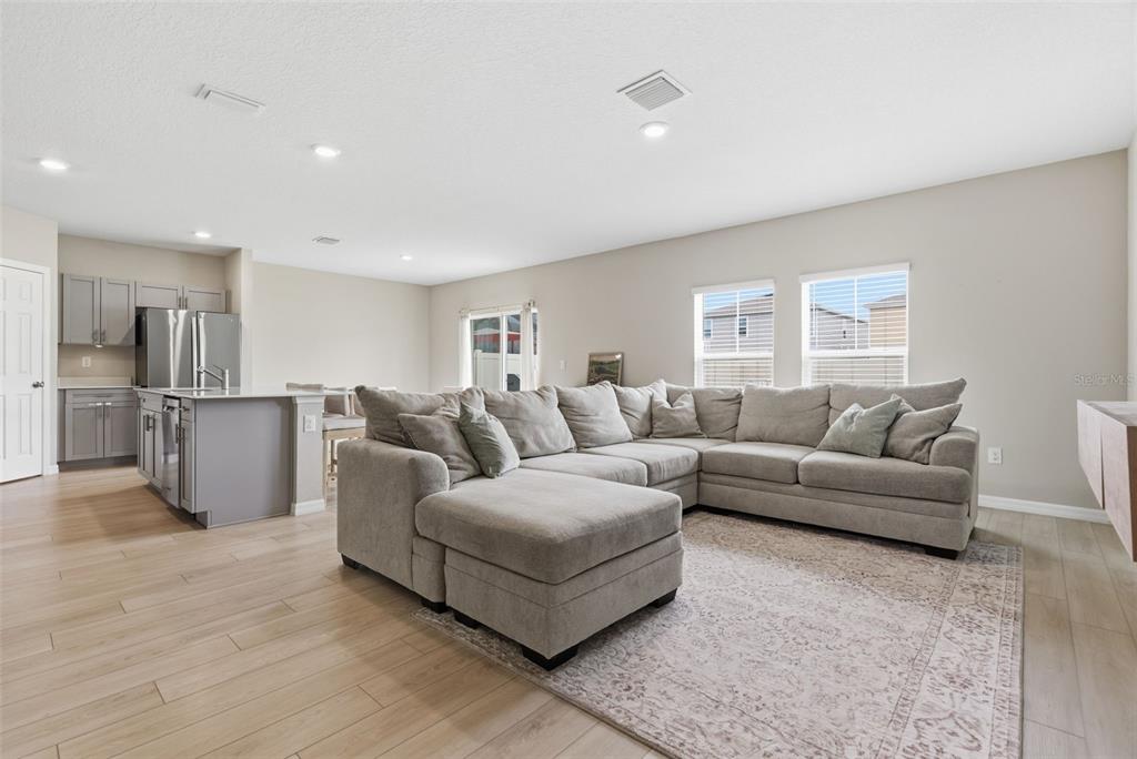 A two-story house with a light green stucco base, teal siding, and a two-car garage — 12950 PASTURE WOODS PLACE, LITHIA, FL